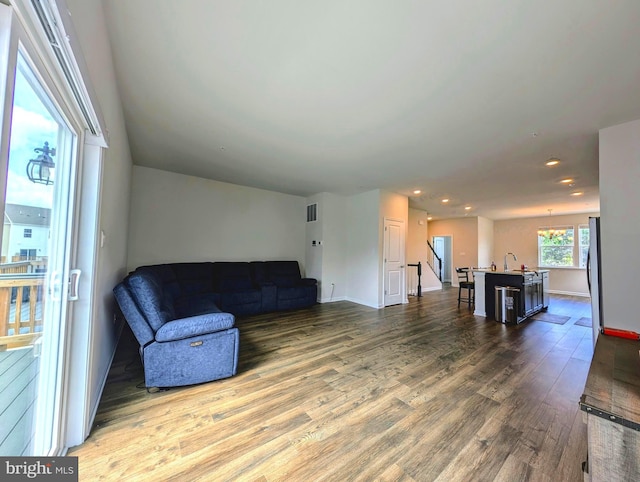 living room featuring sink and hardwood / wood-style flooring