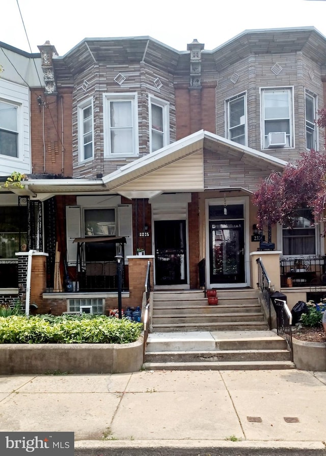 view of front of house featuring cooling unit and covered porch