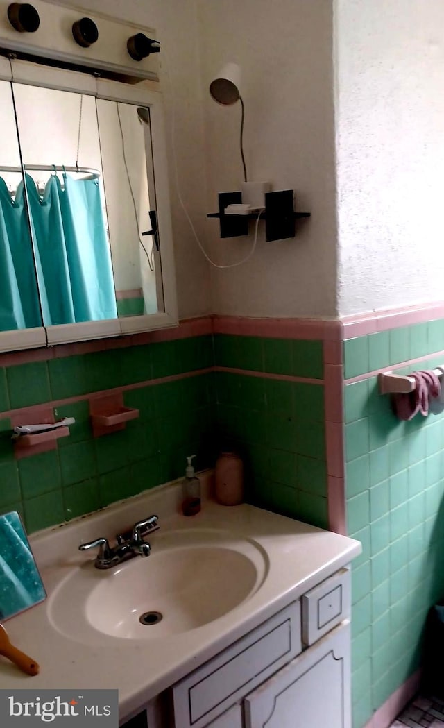 bathroom with tile walls, vanity, and a shower with shower curtain