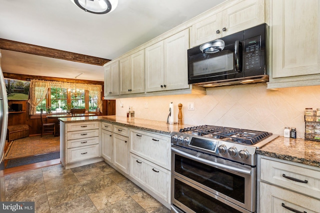 kitchen featuring an inviting chandelier, tasteful backsplash, double oven range, kitchen peninsula, and dark stone counters