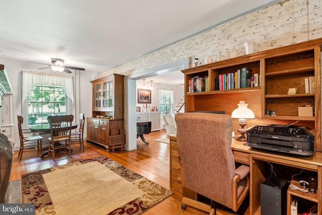 home office featuring hardwood / wood-style floors and ceiling fan