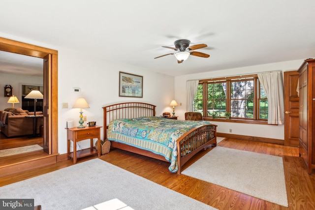 bedroom with hardwood / wood-style floors and ceiling fan