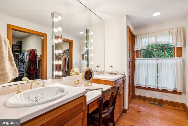 bathroom with vanity and hardwood / wood-style floors