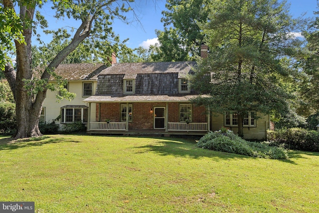 view of front facade with a front lawn and a deck