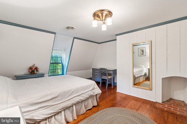 bedroom featuring hardwood / wood-style flooring and ornamental molding