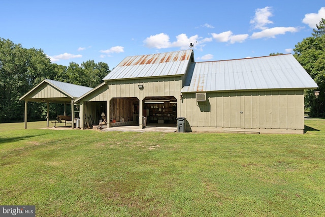 back of property featuring an outdoor structure and a lawn