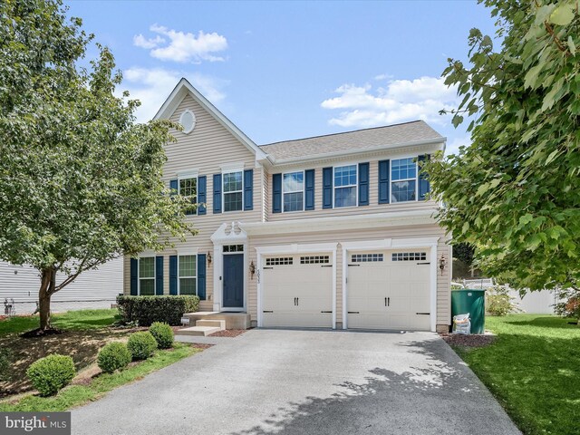 view of front facade featuring a garage and a front lawn