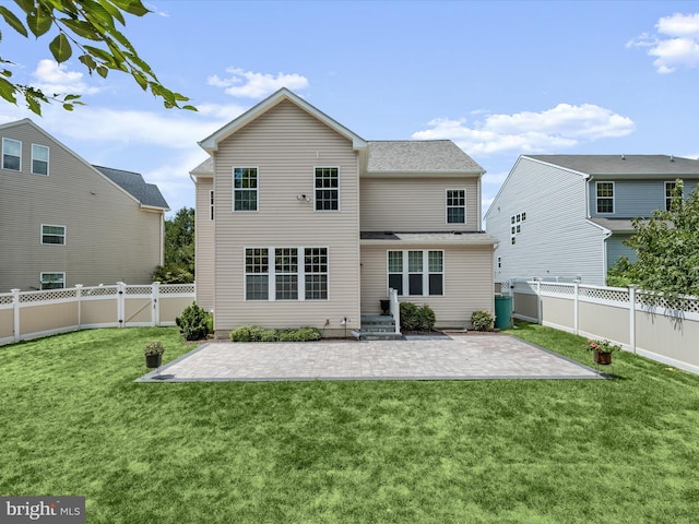 rear view of house featuring a patio area and a lawn