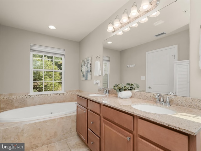 bathroom featuring vanity, tiled bath, and tile patterned floors