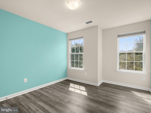 unfurnished room featuring dark wood-type flooring