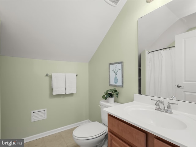 bathroom featuring vanity, toilet, tile patterned flooring, and vaulted ceiling