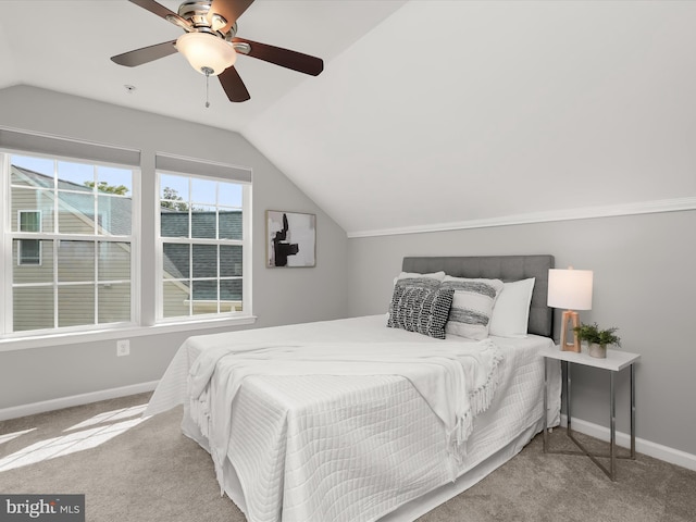 carpeted bedroom with ceiling fan and lofted ceiling