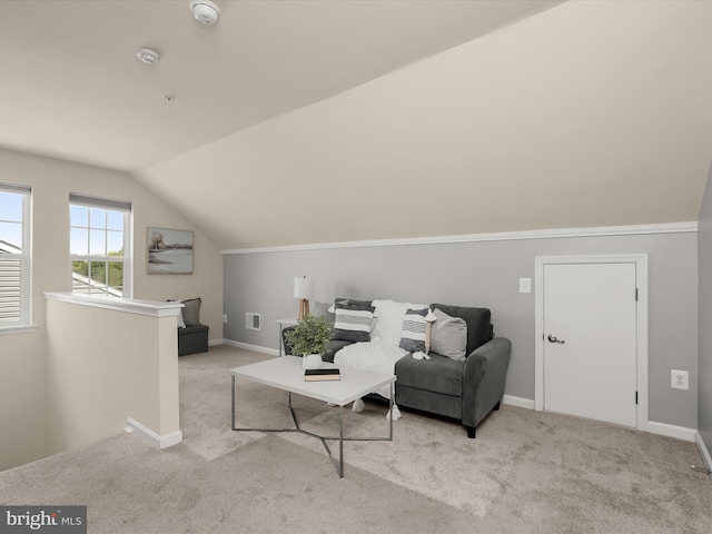 sitting room with light carpet and vaulted ceiling