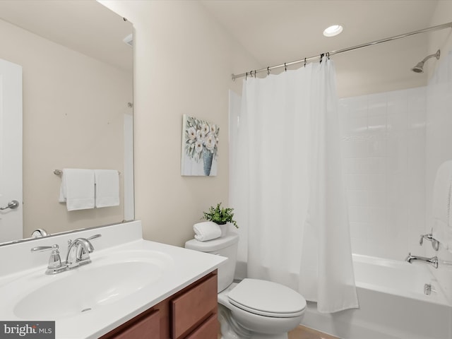 full bathroom with vanity, shower / bath combo, and toilet