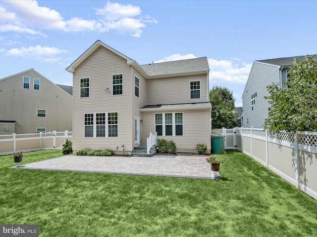 back of house featuring a lawn and a patio area