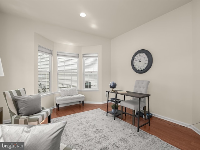 living area with hardwood / wood-style flooring and vaulted ceiling