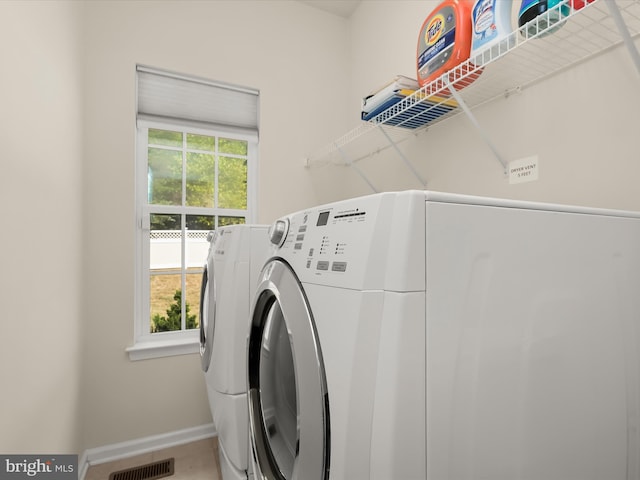 washroom featuring a wealth of natural light and washer and clothes dryer