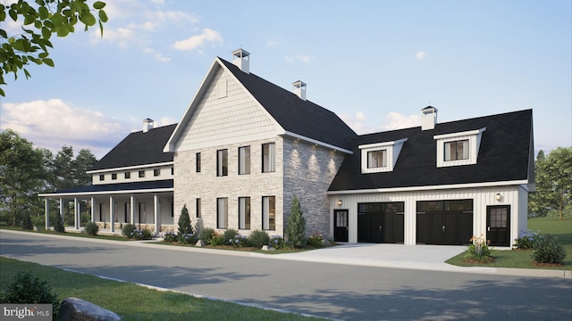 view of front of house featuring covered porch and a garage