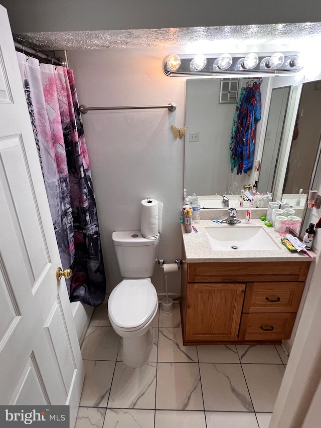 bathroom featuring toilet, vanity, and walk in shower