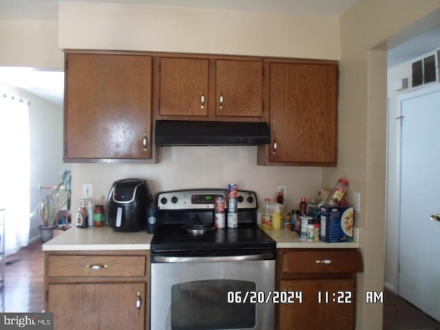 kitchen with electric range and hardwood / wood-style floors