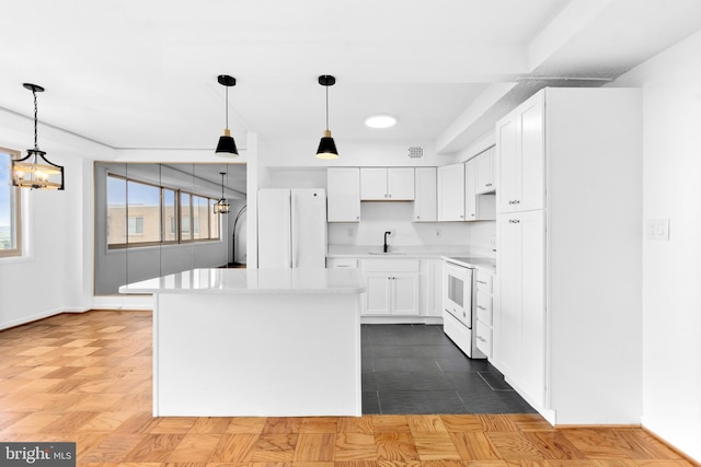 kitchen with parquet flooring, white appliances, white cabinets, hanging light fixtures, and a notable chandelier