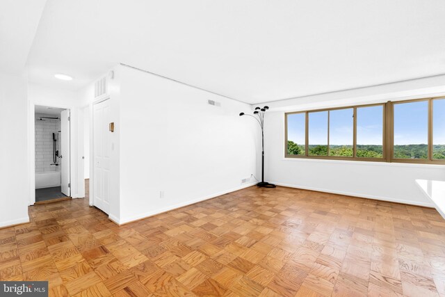 unfurnished room with light parquet flooring