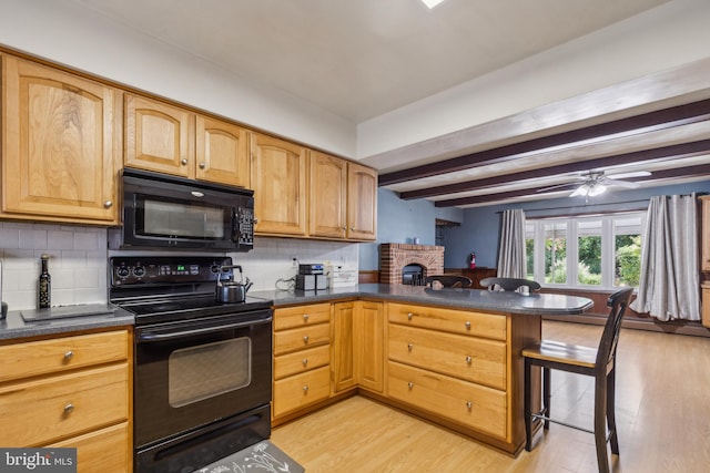 kitchen featuring dark countertops, light wood-style flooring, beamed ceiling, a peninsula, and black appliances