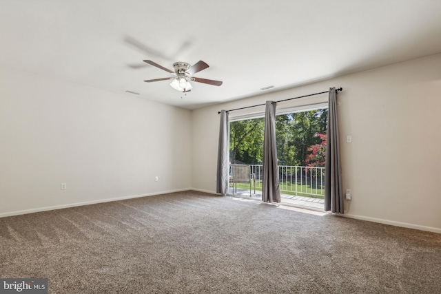 carpeted empty room featuring visible vents, ceiling fan, and baseboards