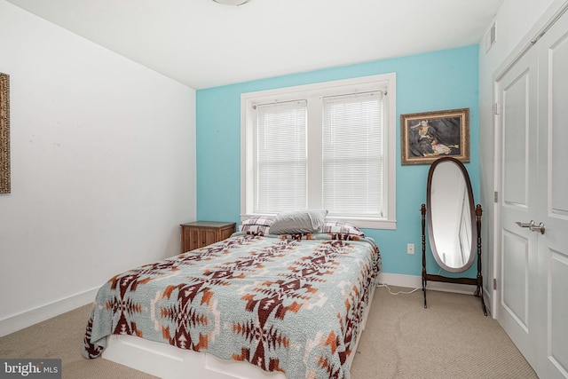 carpeted bedroom featuring a closet