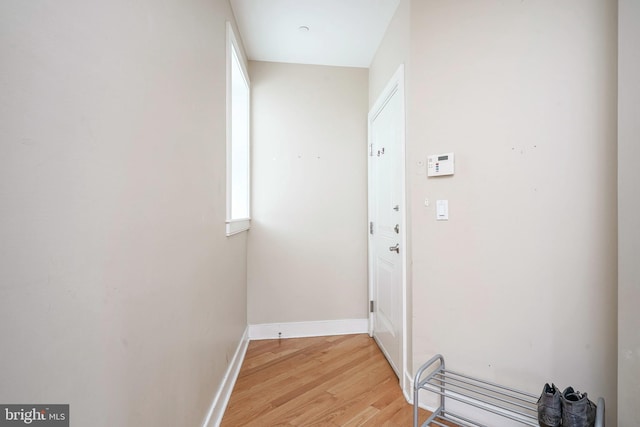 corridor with light hardwood / wood-style floors