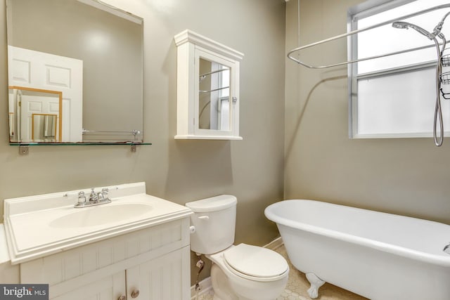 bathroom with vanity, tile patterned flooring, a bathtub, and toilet