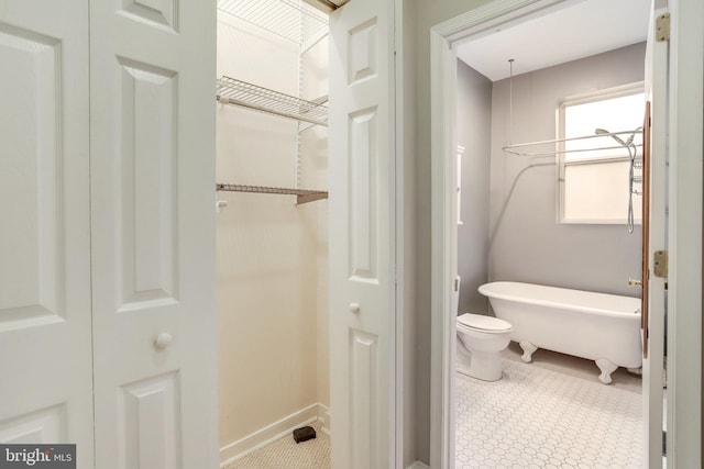 bathroom with tile patterned floors and toilet