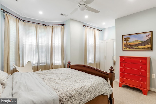 carpeted bedroom featuring a closet and ceiling fan