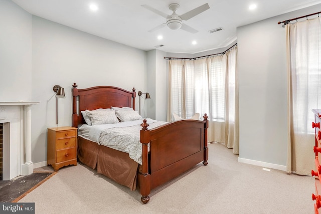 bedroom with light carpet and ceiling fan