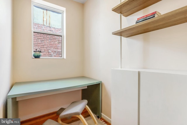 office space with built in desk and hardwood / wood-style floors