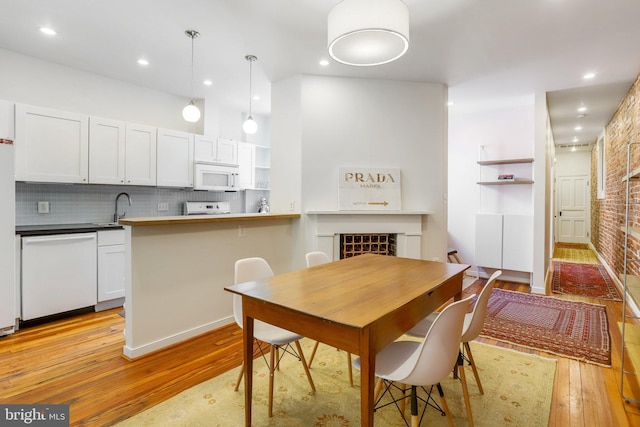 dining room featuring light hardwood / wood-style flooring and sink