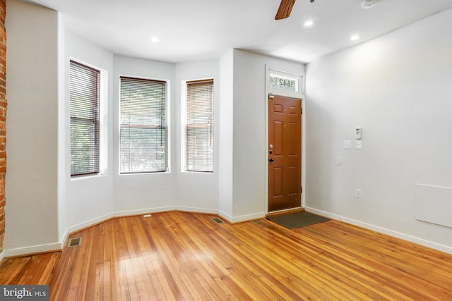 foyer entrance with light hardwood / wood-style flooring, ceiling fan, and plenty of natural light