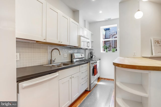 kitchen featuring sink, light hardwood / wood-style flooring, white cabinets, and white appliances