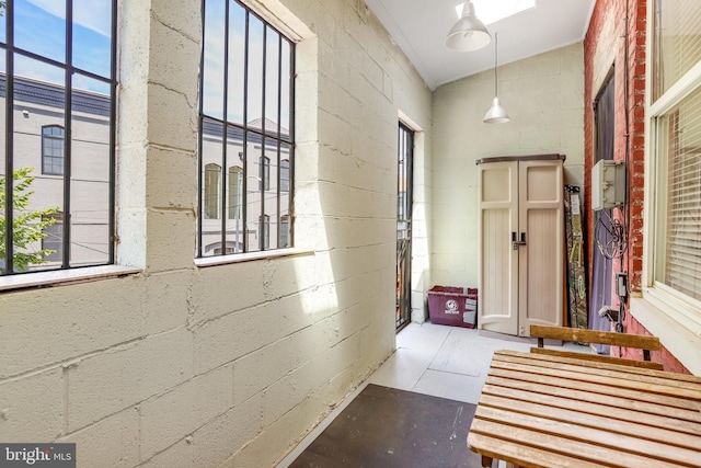 hallway featuring a healthy amount of sunlight and vaulted ceiling