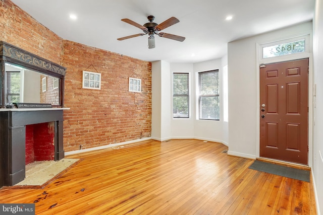 foyer with a wealth of natural light and hardwood / wood-style flooring