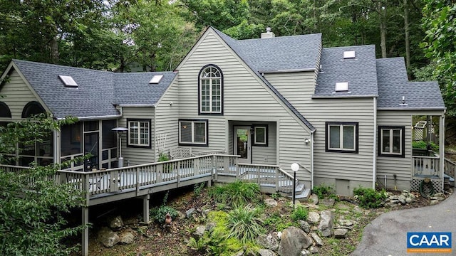 back of house with a sunroom and a deck