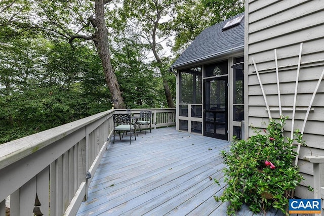 wooden deck featuring a sunroom