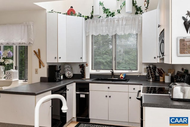 kitchen featuring white cabinetry, sink, and electric range