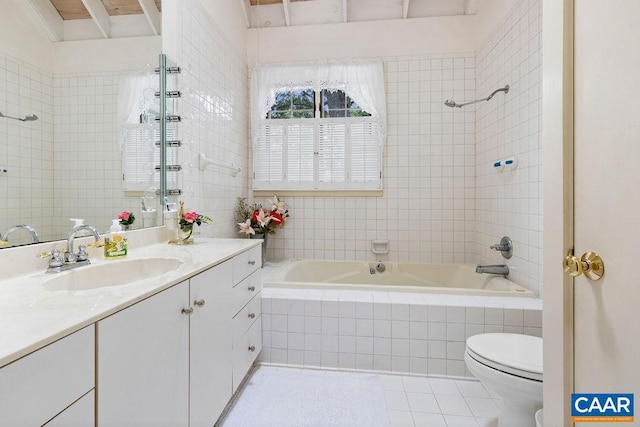 bathroom with vanity, tile patterned floors, toilet, and tile walls