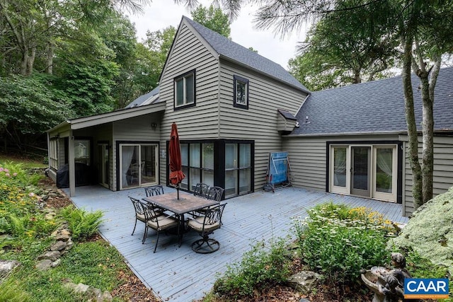 back of house with a wooden deck