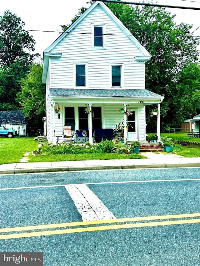 view of front of home with a front lawn and a porch