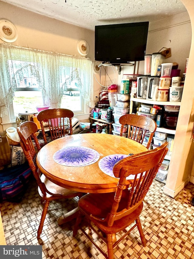 dining space featuring a textured ceiling