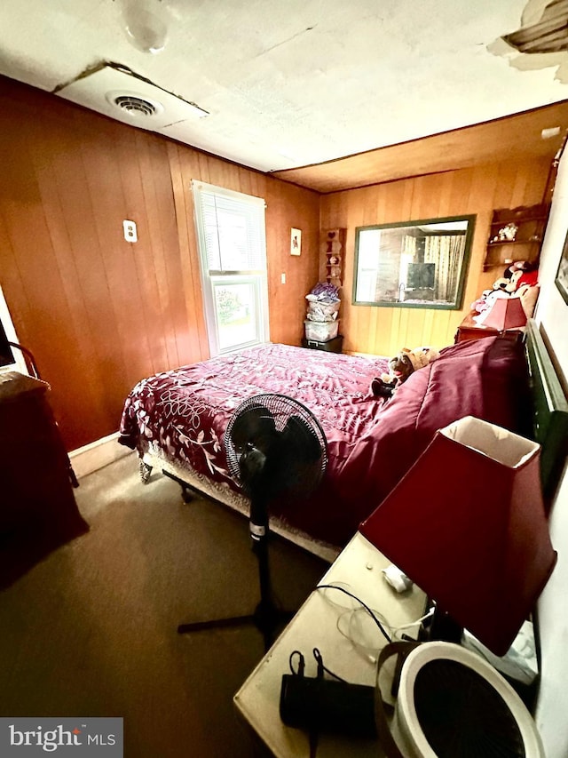 bedroom with carpet and wooden walls