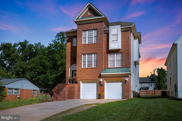 view of front of house with a garage and a yard