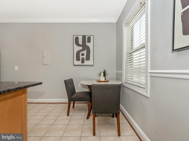 tiled dining room featuring ornamental molding